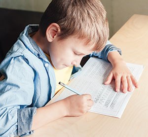 Little boy learning cursive handwriting