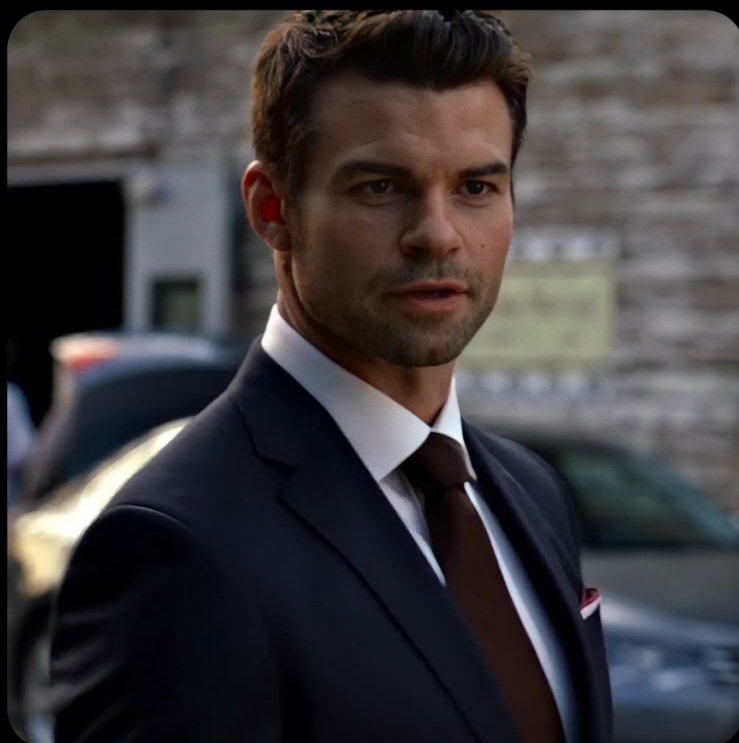Elijah Mikaelson with a glass of bourbon at a ball, AI character from The Originals